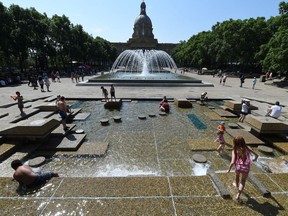 Kids cool off in the fountains at the Provincial Legislature on a hot day in Edmonton on Thursday, July 9, 2015.