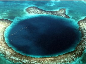 The Blue Hole, a massive aquatic sink hole seen from the air off the coast of Belize. Courtesy, Marina Nelson