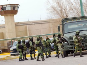 Members of the Mexican Army guard outside the Cereso 3 prison, as authorities transfer inmates from the Cereso 3 prison in Ciudad Juarez to other prisons in the country following an attack where a cartel kingpin escaped along with two dozen other prisoners, according to police, in Ciudad Juarez, Mexico, January 3, 2023.