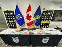 Drugs, guns and ammunition on display on January 25, 2023, following an arrest by ALERT Lethbridge's organized crime unit.