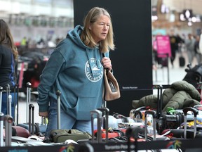 Shannon Koves is searching for her daughter's baggage that was destined for a ski trip to Kelowna for the holidays. She was looking in a roped off sections of Pearson International airport's Terminal 3. A perfect storm of weather broken down luggage conveyors and packed airports have resulted in ongoing chaos for travellers. on Tuesday December 27, 2022. Jack Boland/Toronto Sun/Postmedia Network