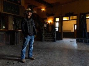 Rose and Crown owner Larry Davis stands inside the well-known Calgary bar, now empty of furnishings, on Tuesday.