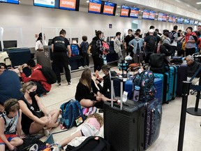 Passengers from Sunwing airlines line up for check-in at Cancun International Airport after many flights to Canada have been canceled because of the severe winter weather conditions.