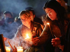 People attend a candlelight vigil for victims of a deadly mass shooting at a ballroom dance studio on January 24, 2023 in Monterey Park, California.