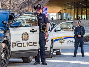 Calgary police officers and Alberta Sheriffs pose for a photo in East Village following a new public safety program announcement on Tuesday, February 14, 2023. A number of Alberta Sheriffs will join CPS officers in their patrol to help curb the safety concerns in downtown Calgary.