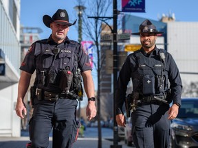 Constable Brad Milne, left, and Alberta Sheriff Prabhjot Singh walk outside the Calgary Police Services East Village Safety Hub following a new public safety program announcement on Tuesday, February 14, 2023. A number of Alberta Sheriffs will join CPS officers in their patrol to help curb the safety concerns in downtown Calgary.