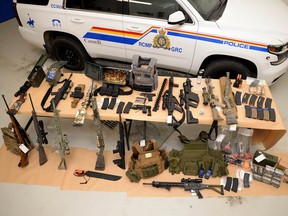 Photo provided by RCMP shows a large assortment of weapons and ammunition seized Feb. 14 near Coutts, Alta., during a crackdown near the Canada/US border.  A number of individuals were arrested.