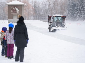 Ice skaters wait for the pond at Bowness park to be cleared after snowfall on Family Day, Monday, February 20, 2023.