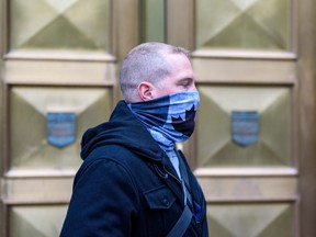 Const. Alexander Dunn, the police officer charged with assault for slamming Dalia Kafi to the floor, walks out of Calgary Courts Centre on Wednesday, October 28, 2020. Azin Ghaffari/Postmedia