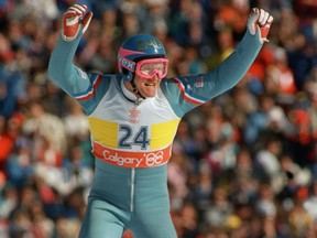 Britain's first ever Olympic ski jumper Eddie Edwards waves to the cheering crowd after completing his first safe jump during the 90m event in Calgary at the XVth Olympic Winter Games. Jonathan Utz Photo/AFP/Getty Images.