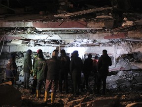 Local people and rescue volunteers attend a search on February 7, 2023 in Elbistan, Turkey.