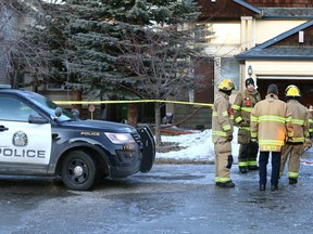 Calgary Firefighers and police are shown at a fire scene on Panatella Drive N.W. in Calgary on Friday, February 17, 2023.