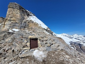 A plaque commemorating the Abbot Pass Refuge Cabin is shown after it was torn down in this undated handout photo.  Parks Canada says a cabin built a century ago by Swiss guides in the Rockies has been significantly removed.  Only a piece of wall, some stone steps and a plaque about the Abbot Pass Refuge Cabin remain on the site that straddles the Continental Divide and the Alberta-British Columbia border.  The cabin was designated a National Historic Site in 1992.  Parks Canada says it had to be torn down due to erosion.