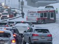 Traffic was snarled along Macleod Trail after buses and cars were stuck on Cemetery Hill following heavy overnight snow in Calgary on Tuesday, February 21, 2023.