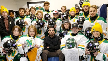 Chris Snow, centre, with son Cohen, behind, and U13 Gold Northstar’s teammates are participating in a sticker campaign to fundraise for ALS in Calgary on Saturday, February 25, 2023.