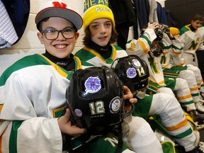 Cohen Snow and U13 Gold Northstar teammates participate in a sticker campaign to raise funds for ALS in support of Cohen's father Chris in Calgary on Saturday, February 25, 2023.