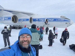 Munish Mohendroo stands in front of a plane near Novolazarevskaya Station in Antarctica before his first run of the World Marathon Challenge on January 31, 2023.