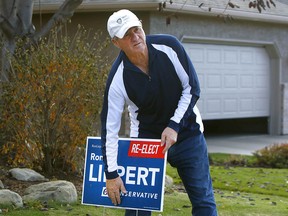Ron Liepert removes campaign signs the day after he was re-elected as Conservative MP in the Calgary Signal Hill riding on Oct. 22, 2019.