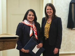 Rajan Sawhney stands with Alberta Premier Danielle Smith after Sawhney was sworn into cabinet as Minister of Trade, Immigration and Multiculturalism in Edmonton, Monday, Oct. 24, 2022. Sawhney says she will not run in the upcoming provincial election.