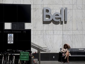 A woman reads outside a Bell Canada office in Toronto, Ontario, Canada on Wednesday, June 22, 2016.