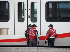 Police and emergency workers investigate at the scene where a pedestrian was hit by a CTrain at the Dalhousie station in northwest Calgary on Tuesday, February 7, 2023.