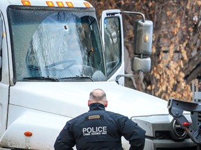 What appears to be an impact hole in the windshield of a truck can be seen on Hendon Drive NW after police shot a man who pointed a firearm at an officer early Wednesday, February 8, 2023.