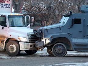 What appears to be an impact hole in the windshield of a truck can be seen on Hendon Drive N.W. after police shot a man who pointed a firearm at an officer early on Wednesday, February 8, 2023.