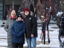 Viktoriia Karman and her two sons Andrii, 12, and Oleksandr, 16, pose for a photo in downtown Calgary on Monday, Feb. 20, 2023. The family fled Ukraine after Russia invaded the country on Feb. 24, 2022.