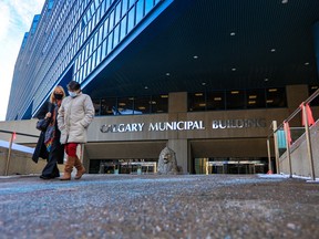 Pedestrians leave City Hall in Calgary on Friday, Dec. 3, 2021.