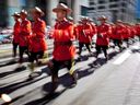 Members of the Royal Canadian Mounted Police march during the Calgary Stampede parade in Calgary, Friday, July 6, 2012.