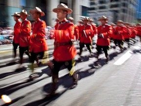 Members of the Royal Canadian Mounted Police march during the Calgary Stampede parade in Calgary, Friday, July 6, 2012.