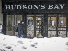 A man walks by the Hudson's Bay in Calgary on Wednesday, March 18, 2020.