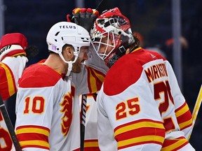 Calgary Flames center Jonathan Huberdeau (10) celebrates with goalie Jacob Markstrom (25) after the game against the Philadelphia Flyers at Wells Fargo Center.