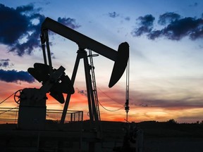 A pump power pulls oil from a wellhead near Calgary, Alta., Saturday, Sept. 17, 2022.