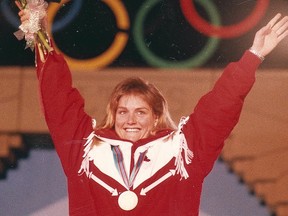 Skier Karen Percy waves to the crowd at Olympic Plaza after receiving a bronze medal during the 1988 Winter Olympics. Calgary Herald archives.