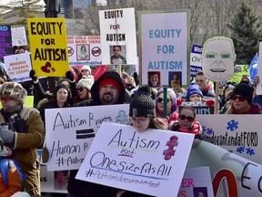 Hundreds of parents, therapists and union members gather outside Queen's Park, in Toronto on Thursday, March 7, 2019, to protest the provincial government's changes to Ontario's autism program.