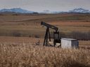 A decommissioned pump jack is shown Saturday, Oct. 29, 2016, at a wellhead on an oil and gas installation near Cremona, Alta.  The Alberta government is moving ahead with a plan that would give oil and gas companies a tax break for meeting their legal obligations to clean up old well sites.