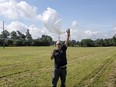 Ed Harrison launches a so-called pico balloon, which costs about $12 and is about 32 inches in diameter, in a field near Collierville, Tenn.