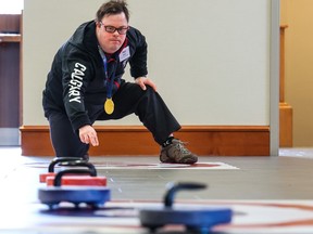 Special Olympics athlete Paul Sawka demonstrates indoor curling as part of the countdown to the 2024 Special Olympics Canada Winter Games Calgary.
