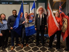 From left: pistol shooter Lynda Kiejko, track and field athlete Sam Effah, gymnastics athlete Kyle Shewfelt, Chief Roy Whitney of Tsuut'ina Nation and wrestler Erica Wiebe pose for a photo after a media event where Alberta Community Builders gathered to introduce to announce  A Commonwealth Games bid scout on Wednesday, 8 March 2023.