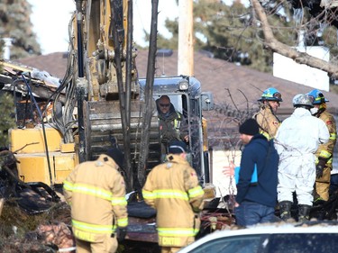 Investigators comb through the rubble at the scene of an explosion on Maryvale Way NE in Calgary on Monday, March 27, 2023. At least 10 people were injured in the blast.