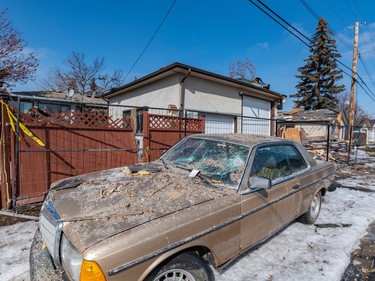 A car remains covered in debris after the house explosion that rocked Calgary's Marlborough neighbourhood on March 28.