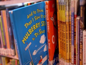 Children's books are seen on library shelves.