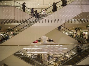 Shoppers take the escalators looking for Boxing Day deals at a Nordstrom store in downtown Toronto on Monday, Dec. 26, 2017. Nordstrom Inc. says it is winding down its Canadian operations and closing all of its stores in the country.