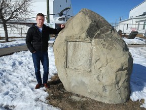 Brian Desjardins, Executive Director at the Hangar Flight Museum, poses on Tuesday, March 21, where one of 10 stolen plaques were mounted on sandstone boulders in front of the Museum on McCall Way in northeast Calgary.