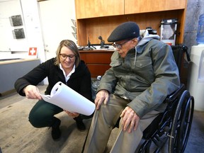 Jade Getz, VP Development and Design, shows plans and drawings as she joins Eric Haffenden in the Barron Building on March 29.