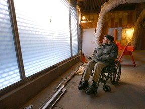 Eric Haffenden, a former carpenter, pauses as he visits the Barron Building job site in downtown Calgary on Wednesday, March 29.