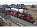 A Canadian Pacific Railway locomotive crosses a bridge in Calgary, Alberta, Canada, on Sunday, March 20, 2022. Canadian Pacific Railway entered a work stoppage early Sunday after the company and union leadership were unable to ' to negotiate a settlement or vote to be binding.  arbitration.