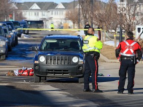 Calgary police investigate at the scene where a child was seriously injured after being hit by a Jeep SUV on Royal Oak Drive on Monday, March 20, 2023.