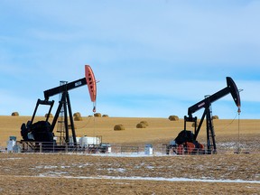 FILE PHOTO: Pumpjacks are framed by a wheat field near Cochrane on Wednesday March 4, 2020.